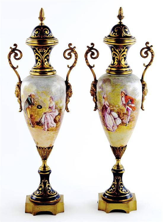 Appraisal: Pair French ormolu-mounted porcelain covered urns circa acorn finial on