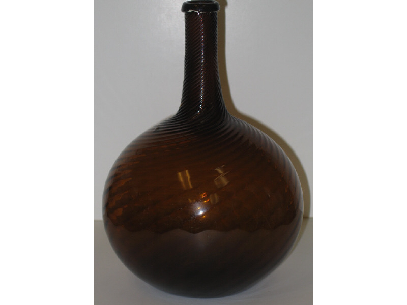 Appraisal: ZANESVILLE OHIO MOLDED GLOBULAR BOTTLE Amber swirl ribbed to the