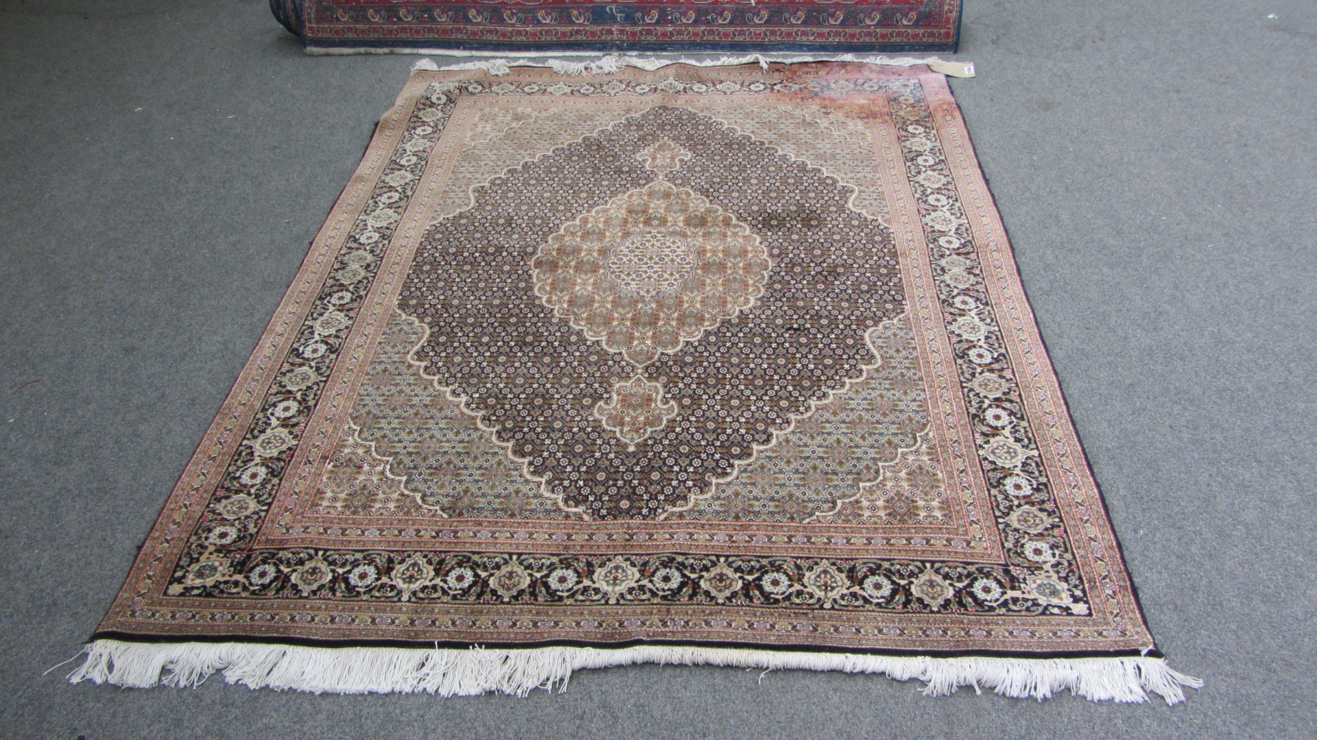 Appraisal: An Indian rug the black field with a lobed medallion