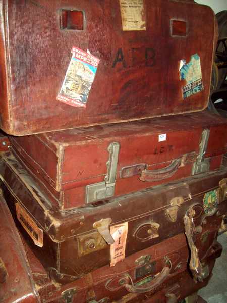 Appraisal: A COLLECTION OF FIVE LEATHER SUITCASES AND TWO CANVAS SUITCASES