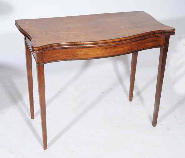 Appraisal: A GEORGIAN MAHOGANY SERPENTINE FOLD OVER CARD TABLE standing on