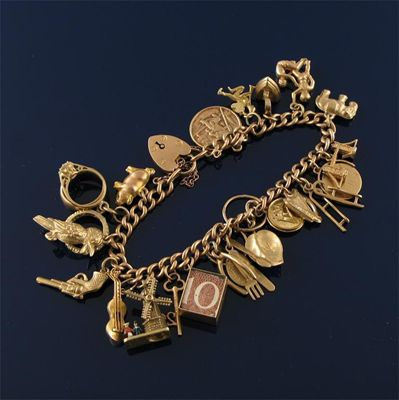 Appraisal: A ct gold bracelet with twenty two ct gold charms