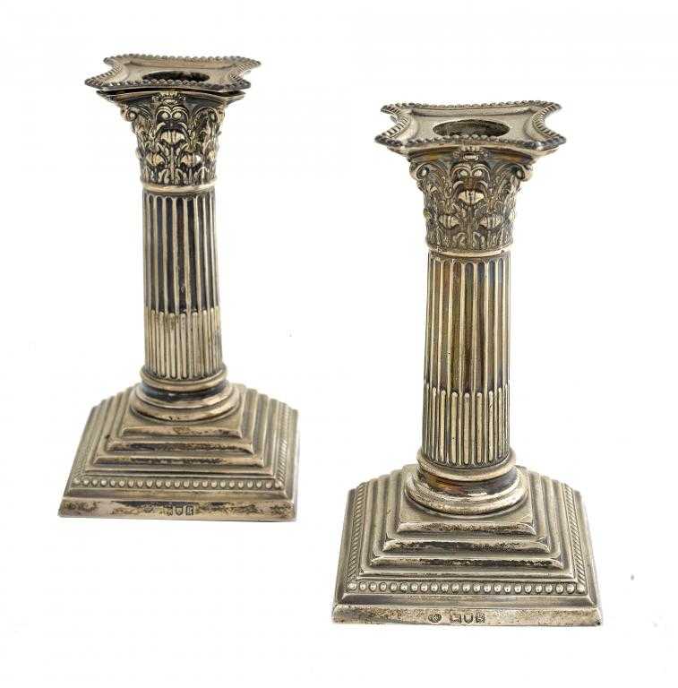 Appraisal: A PAIR OF EDWARD VII DWARF COLUMNAR CANDLESTICKS with beaded