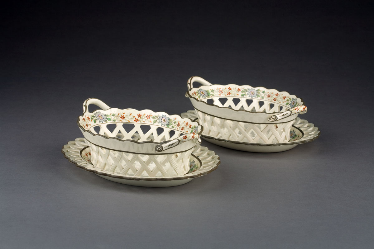 Appraisal: PAIR OF ENGLISH CREAMWARE ENAMEL-DECORATED BASKETS AND STANDS CIRCA Each