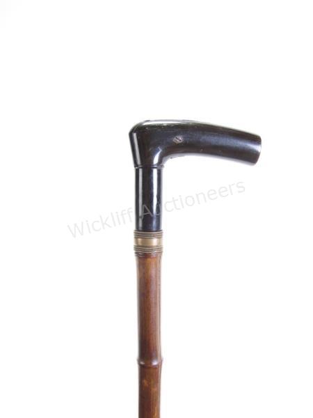 Appraisal: Bamboo Gun Cane bamboo shaft metal and ebony handle unscrews