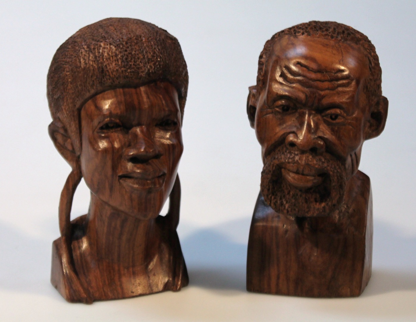 Appraisal: Two African hardwood tribal heads each carved cm high