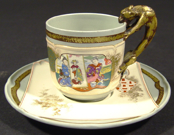 Appraisal: Aesthetic pottery cup and saucer decorated in the Chinese manner