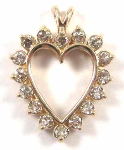 Appraisal: DIAMOND AND FOURTEEN KARAT GOLD PENDANT The open heart shaped