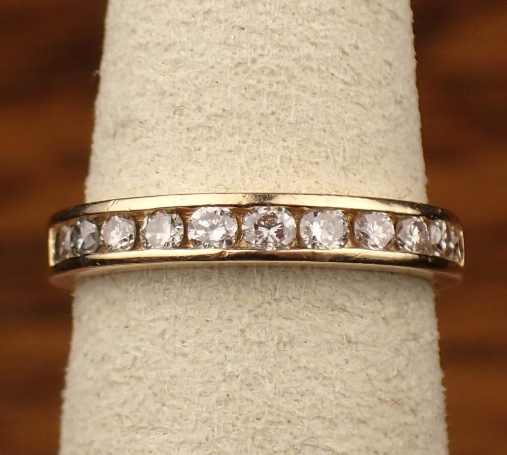 Appraisal: DIAMOND AND FOURTEEN KARAT GOLD ANNIVERSARY BAND The yellow gold