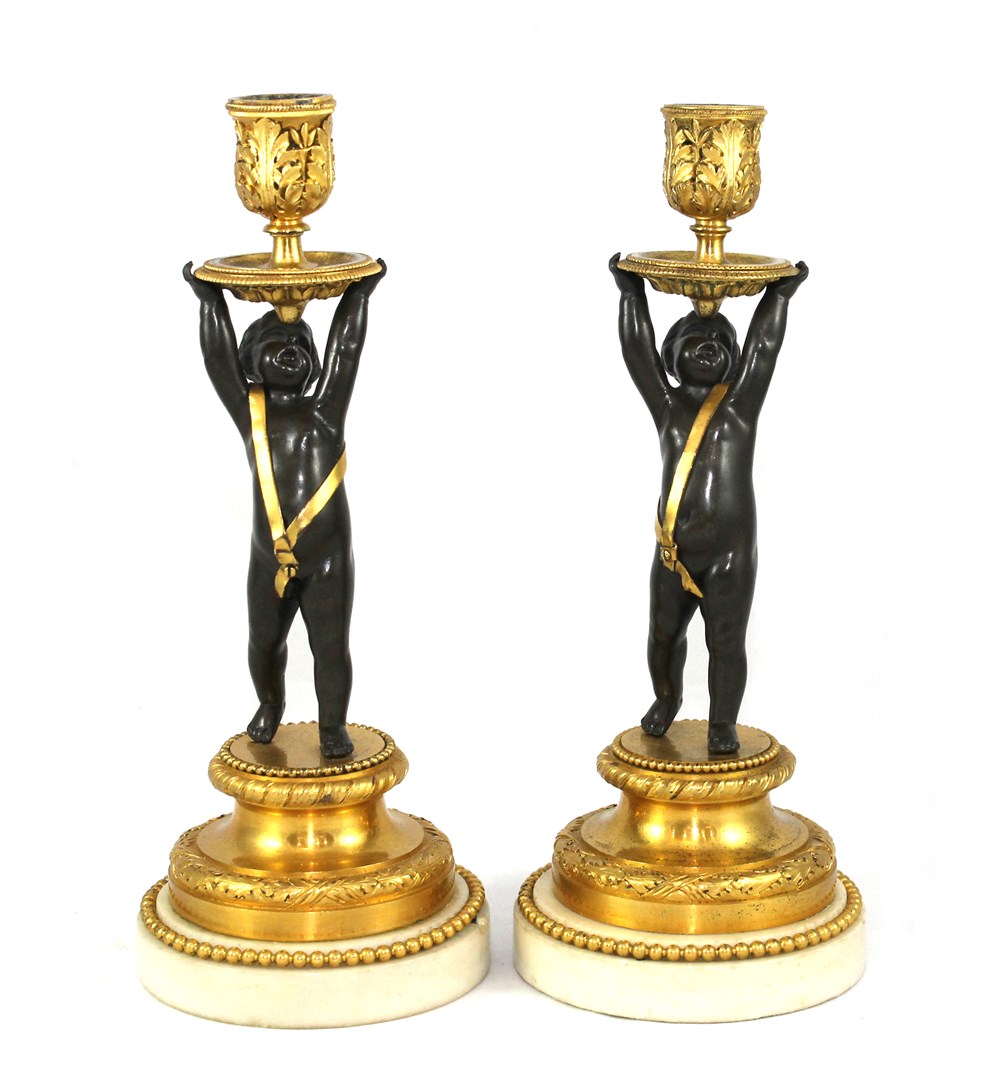 Appraisal: A pair of restoration bronze parcel gilt and marble candlesticks