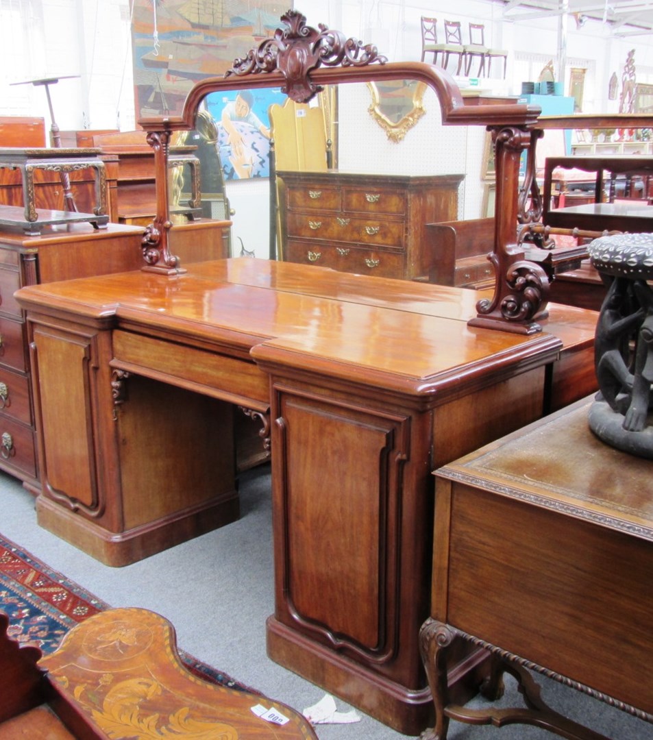 Appraisal: A Victorian mahogany sideboard with mirrored back over central door