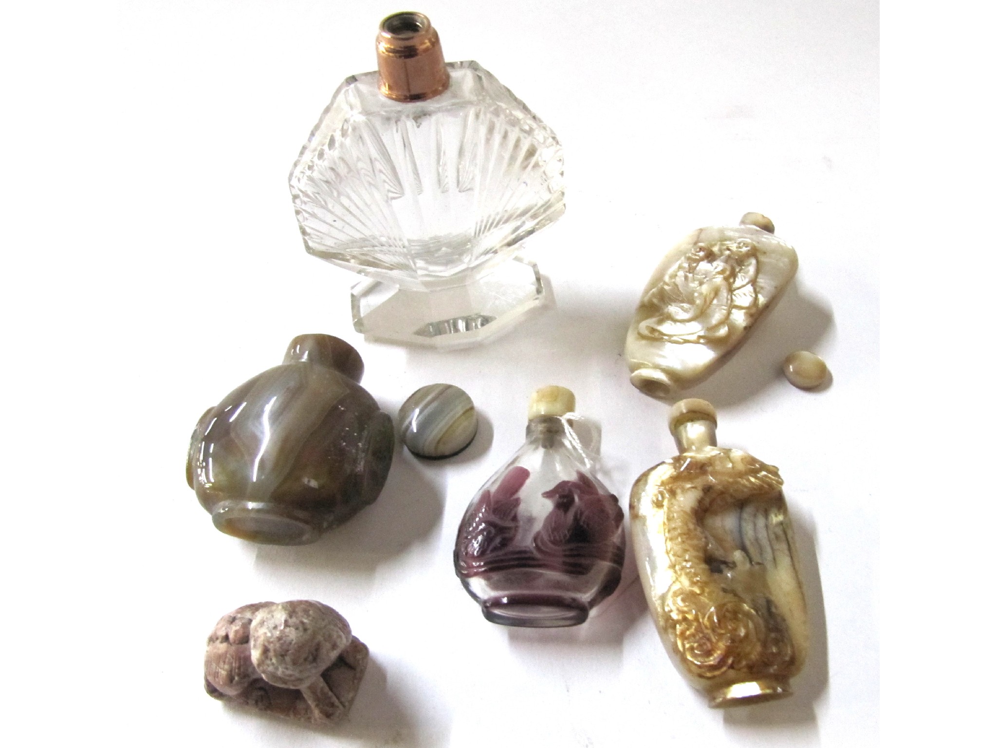 Appraisal: A lot comprising four oriental snuff bottles a carved figure