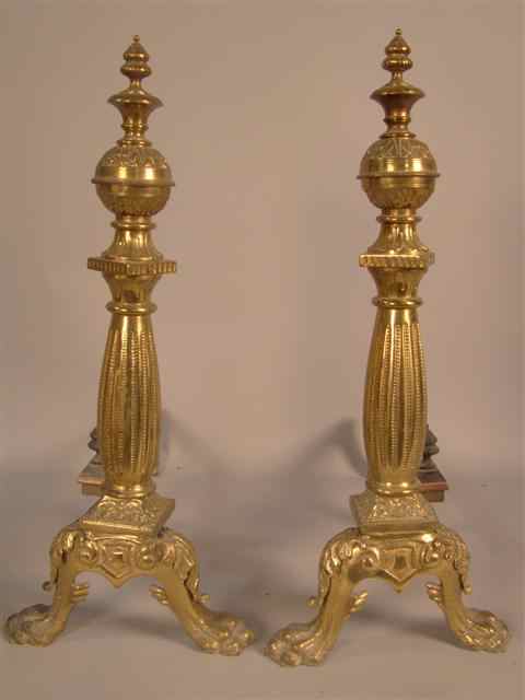 Appraisal: PAIR OF CLASSICAL BRASS ANDIRONS with foliate capital above an