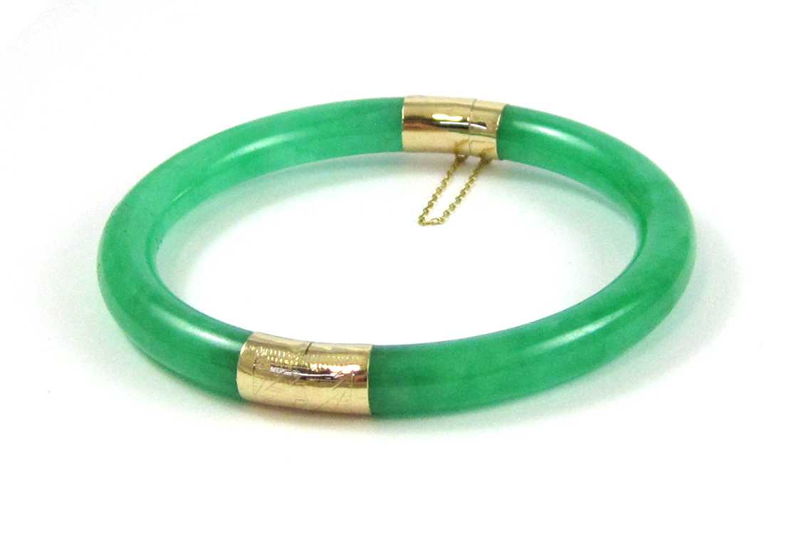 Appraisal: GREEN JADE AND FOURTEEN KARAT YELLOW GOLD BANGLE a ring