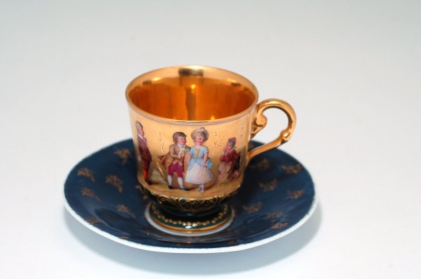 Appraisal: Cup and saucer having gold ground with figures of children