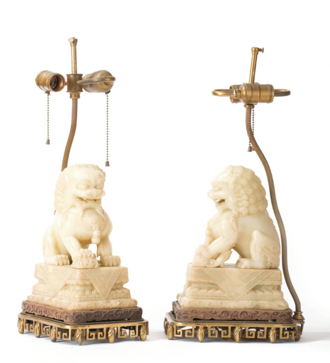 Appraisal: PAIR OF CHINESE CARVED IVORY SOAPSTONE FOO LIONS NOW FITTED