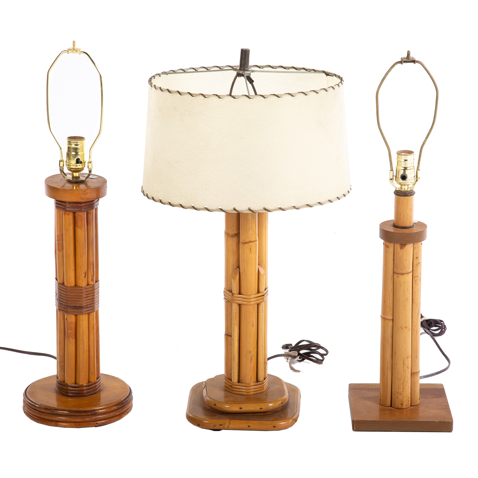 Appraisal: THREE PAUL FRANKL STYLE RATTAN TABLE LAMPS Mid-century with circular