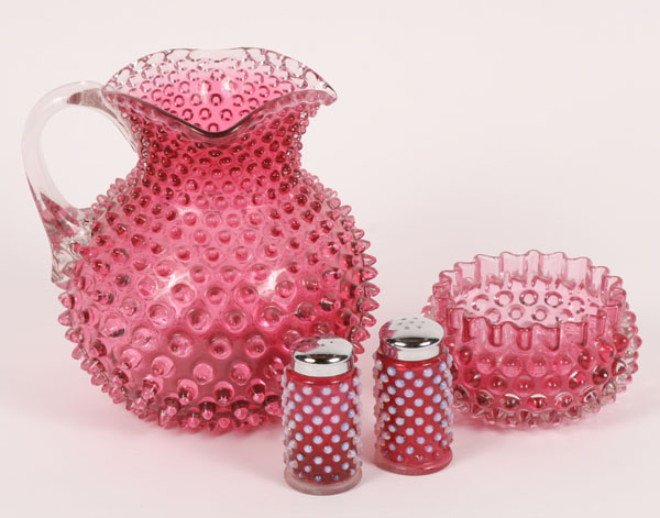 Appraisal: Four pieces cranberry glass hobnail pitcher with applied clear handle