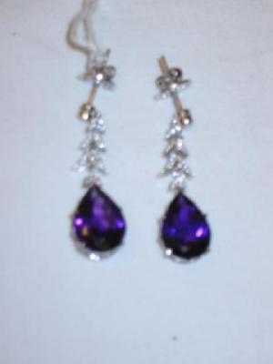 Appraisal: A PAIR OF AMETHYST AND DIAMOND DROP EARRINGS comprising pear