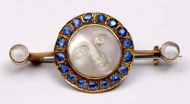 Appraisal: A MOONSTONE AND SAPPHIRE BROOCH central 'Man in the Moon'