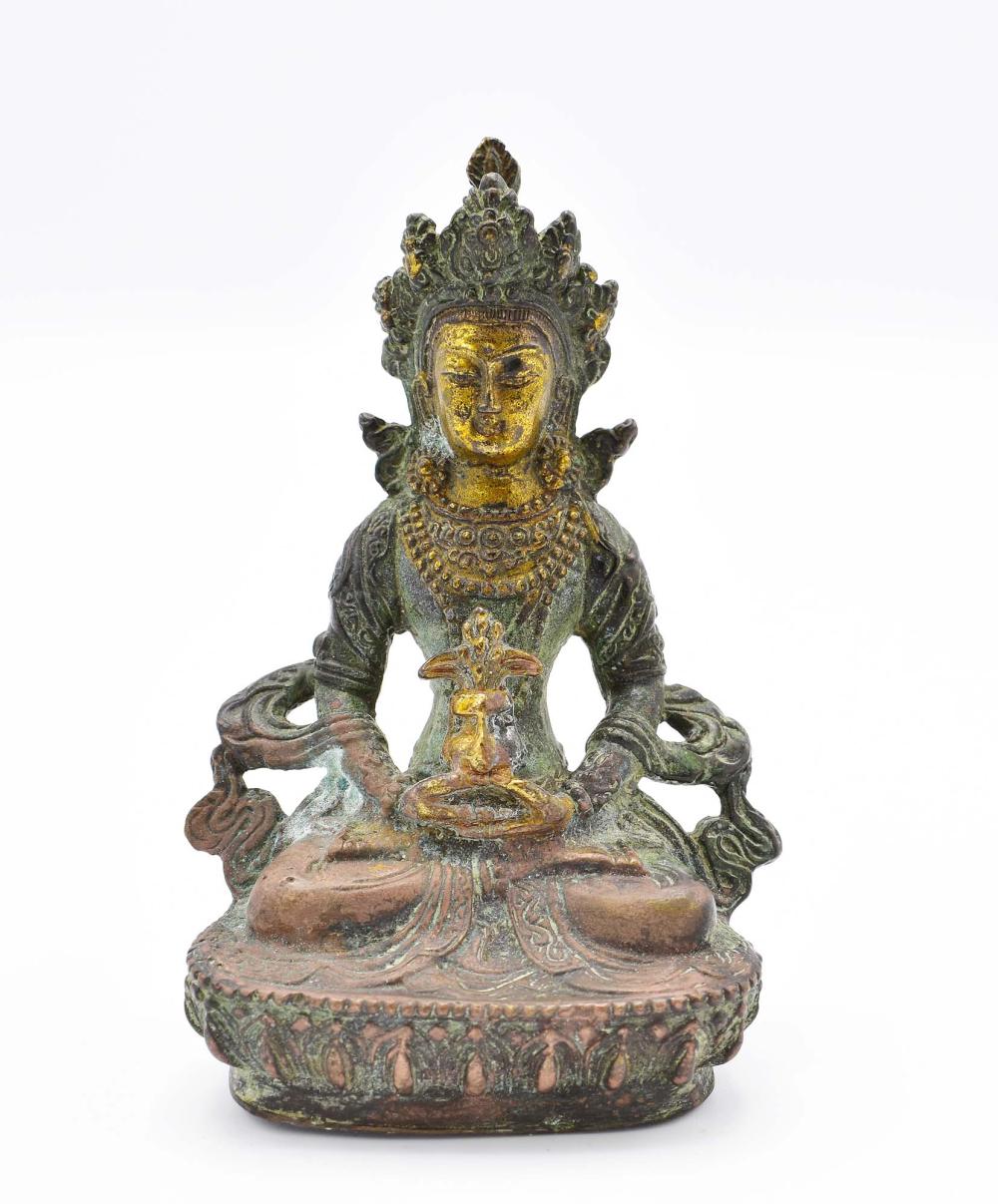 Appraisal: SINO-TIBETAN BRONZE SEATED DEITYIn elaborate robes with headdress seated cross-legged