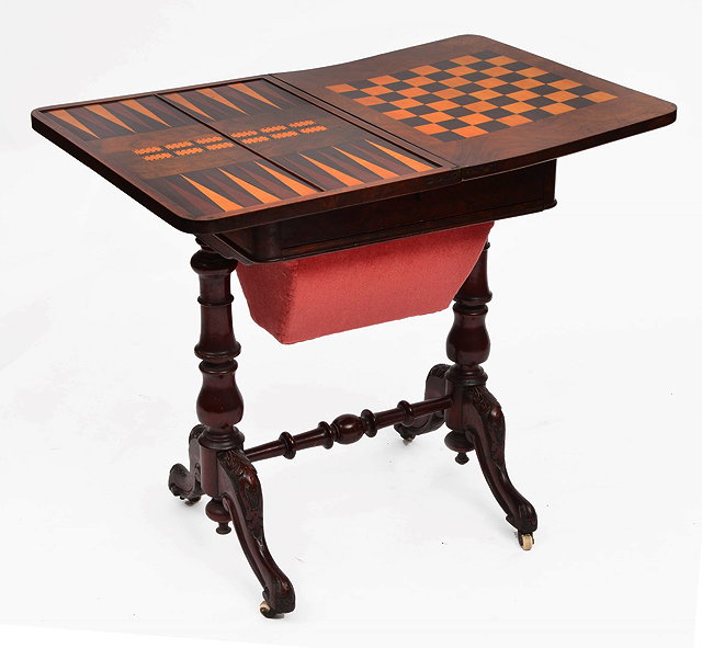 Appraisal: A VICTORIAN FIGURED WALNUT RECTANGULAR GAMES TABLE with fold over