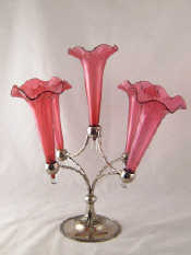 Appraisal: A silver plated epergne with five cranberry glass vases ht