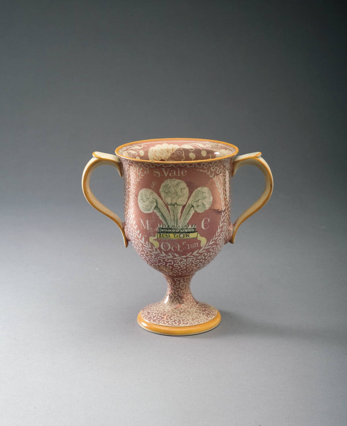 Appraisal: BRITISH PINK RESIST LUSTRE AND ENAMEL-DECORATED ROYAL COMMEMORATIVE GOBLET POSSIBLY