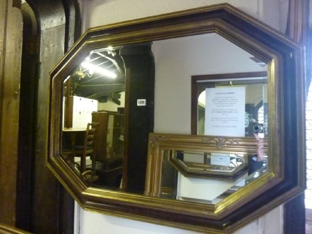 Appraisal: A contemporary wall mirror of elongated octagonal form with stepped