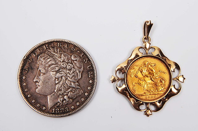 Appraisal: A sovereigndated together with an American silver dollar