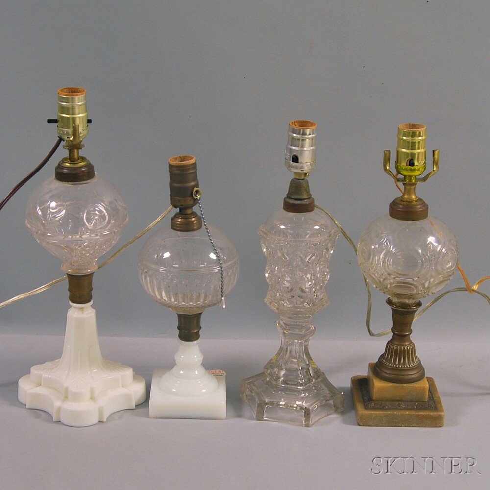 Appraisal: Four Colorless Glass Kerosene Lamps two on opalescent glass bases