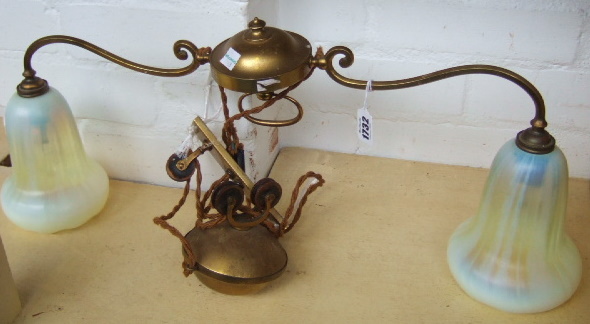 Appraisal: A brass and glass adjustable twin branch ceiling light circa