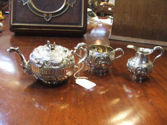 Appraisal: AN ORIENTAL WHITE METAL THREE PIECE TEA SET chased with