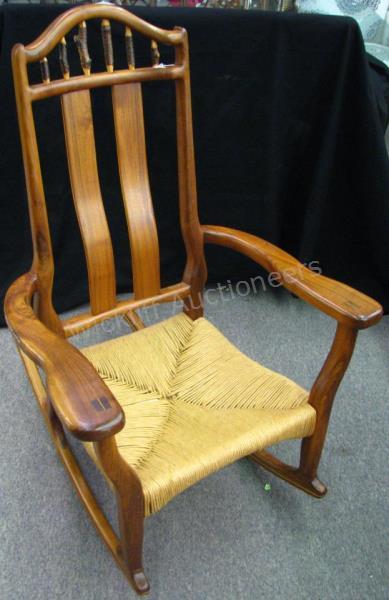 Appraisal: A vintage rocking chair with rush-tied seat solid wood frame