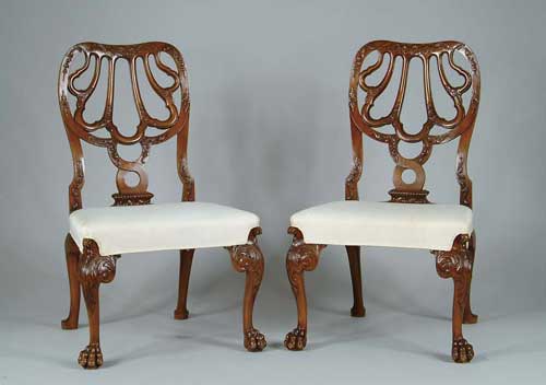 Appraisal: PAIR OF REPRODUCTION FANCY CARVED CHIPPENDALE SIDE CHAIRS The pierced