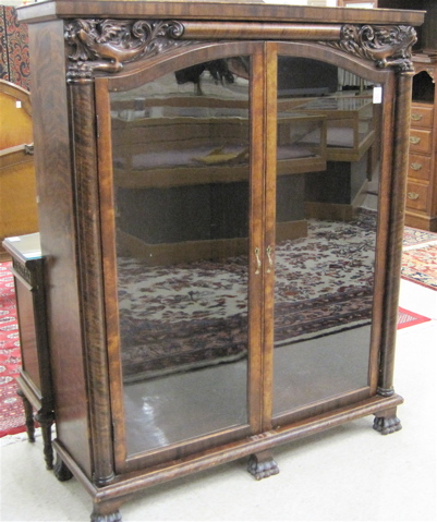 Appraisal: EMPIRE REVIVAL MAHOGANY CABINET BOOKCASE American c having three adjustable