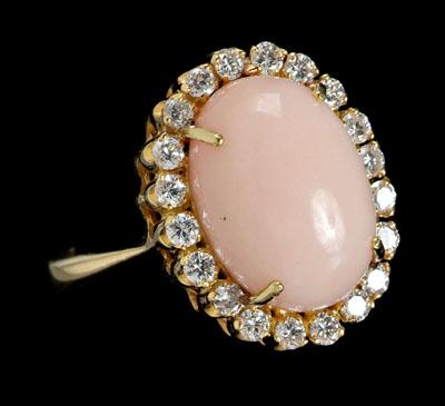 Appraisal: Coral diamond ring central oval pink coral cabochon surrounded by