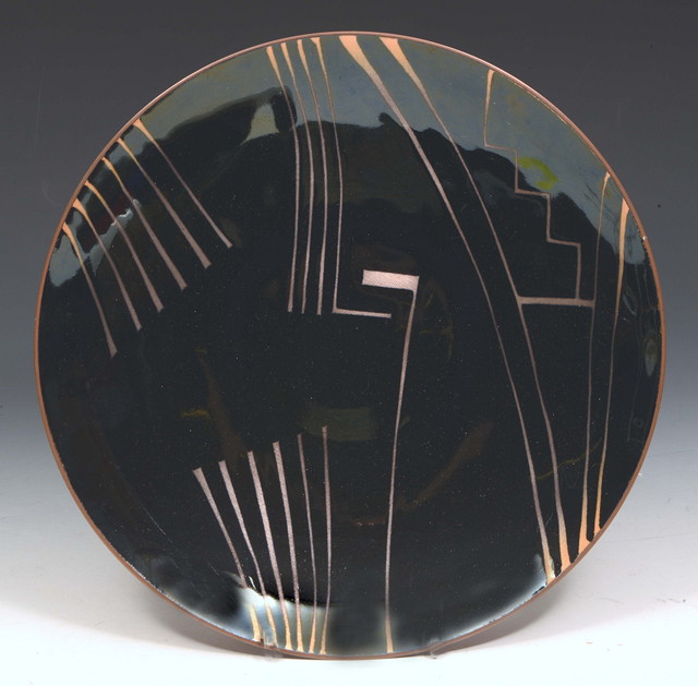 Appraisal: Ann Robin Banks British - Charger black and copperinitialled 'RB'enamel