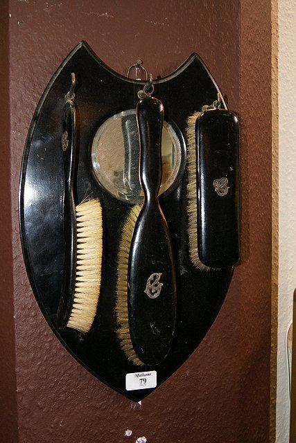 Appraisal: AN EDWARDIAN EBONISED GENTLEMANS MANICURE SET on a shield shaped