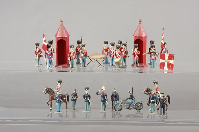 Appraisal: Lot of metal figures with tin guard houses representing Danish