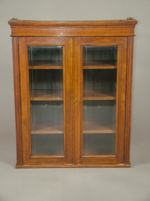 Appraisal: An oak glazed upper section of a bookcase late th