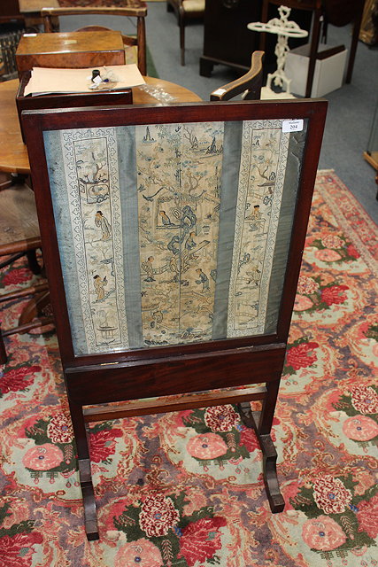 Appraisal: A VICTORIAN MAHOGANY FIRE SCREEN with inset Oriental embroidered panels