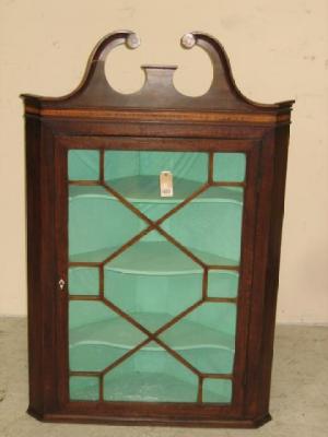 Appraisal: A GEORGE III MAHOGANY CORNER CUPBOARD c the moulded swan