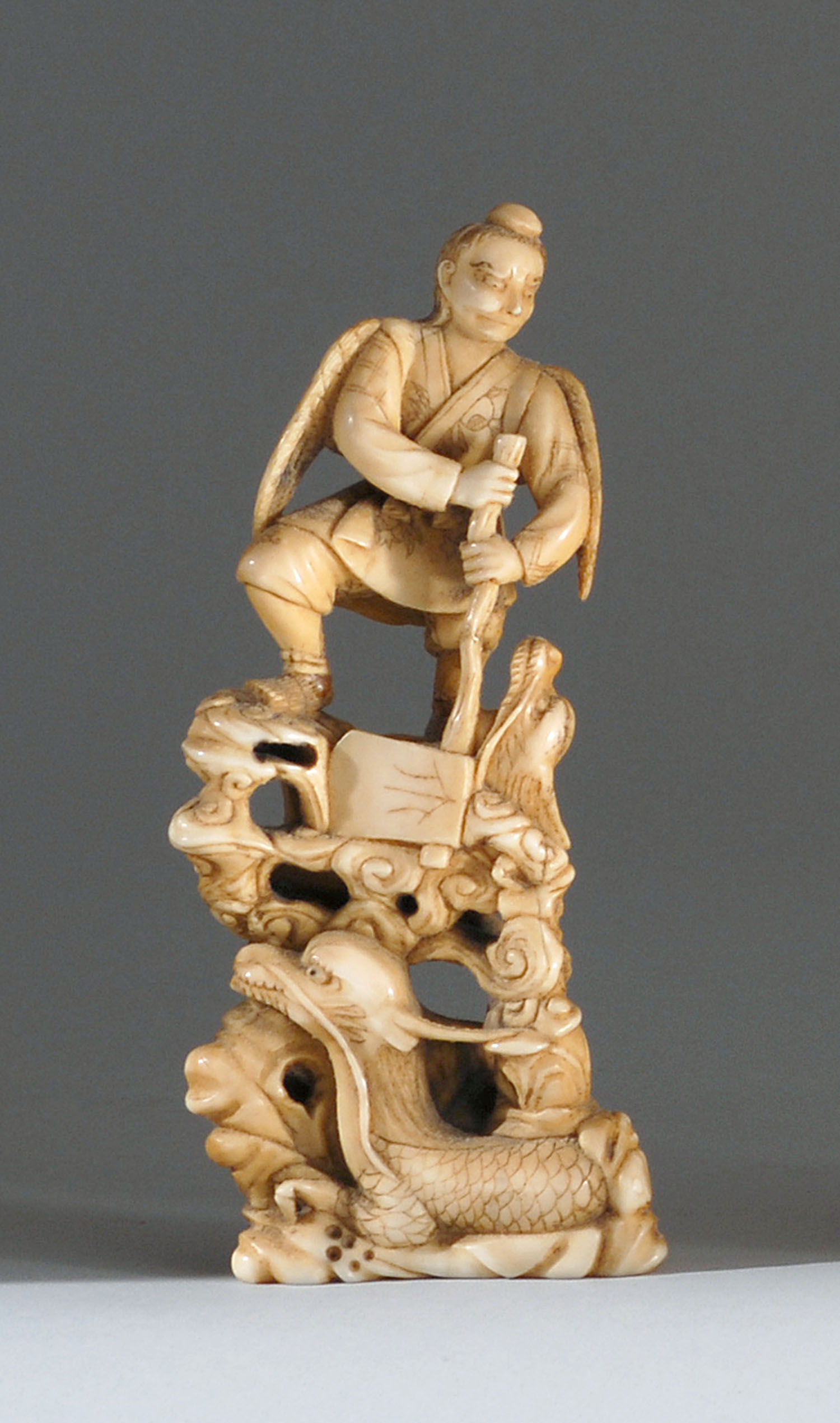 Appraisal: IVORY FIGURE Meiji PeriodDepicting a winged tengu and dragons Height