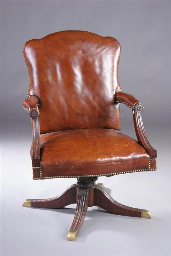 Appraisal: GEORGIAN STYLE LEATHER LIBRARY CHAIR th century mahogany Triple-lobed crest