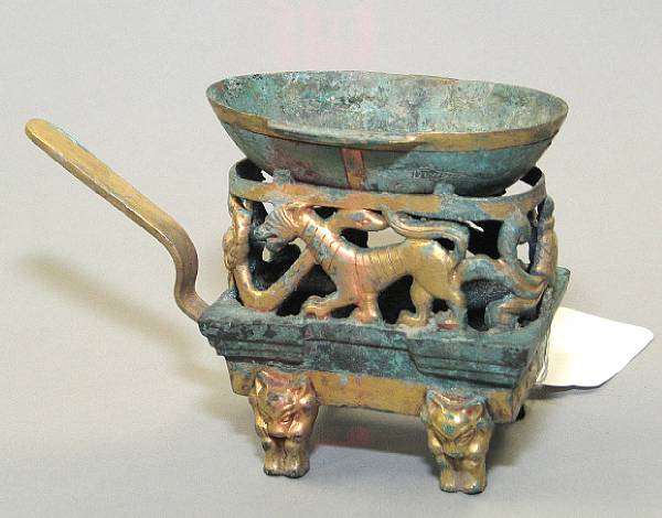 Appraisal: A Han style gilt and patinated copper alloy double-ear cup