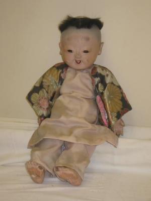 Appraisal: A composition Japanese boy doll with fixed brown glass eyes