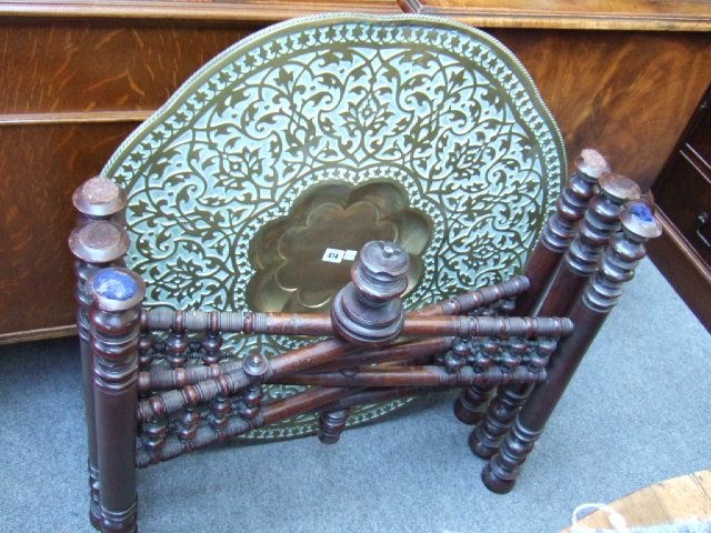 Appraisal: A Middle Eastern folding hardwood table with brass tray top