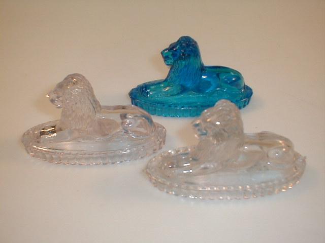 Appraisal: Three Derbyshire type pressed glass seated lions long