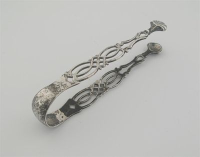 Appraisal: A pair of George III cast arm sugar tongs crested